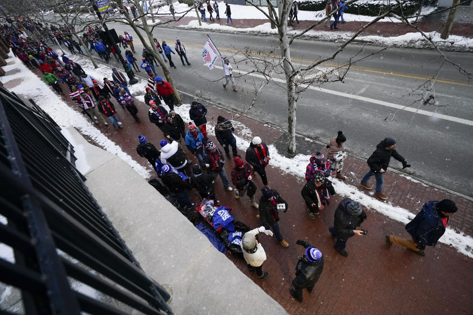 A group of United States men's national soccer team supporters march to Lower.com Field ahead of a FIFA World Cup qualifying soccer match against El Salvador, Thursday, Jan. 27, 2022, in Columbus, Ohio. (AP Photo/Julio Cortez)