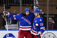 New York Rangers' Mika Zibanejad, left, celebrates with Chris Kreider (20) after scoring a goal against the New Jersey Devils during the first period of an NHL hockey game Friday, March 4, 2022, in New York. (AP Photo/Frank Franklin II)