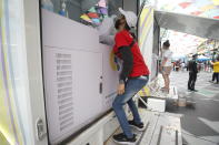 A man undergoes a swab test at a COVID-19 mobile testing unit in Khaosan Road in Bangkok, Thailand Wednesday, April 14, 2021. Thailand recorded more than 1,000 COVID-19 infections on Wednesday, setting a daily record and adding pressure on the government to do more to control the country's spiking transmission rates. (AP Photo/Somchai Chanjirakitti)