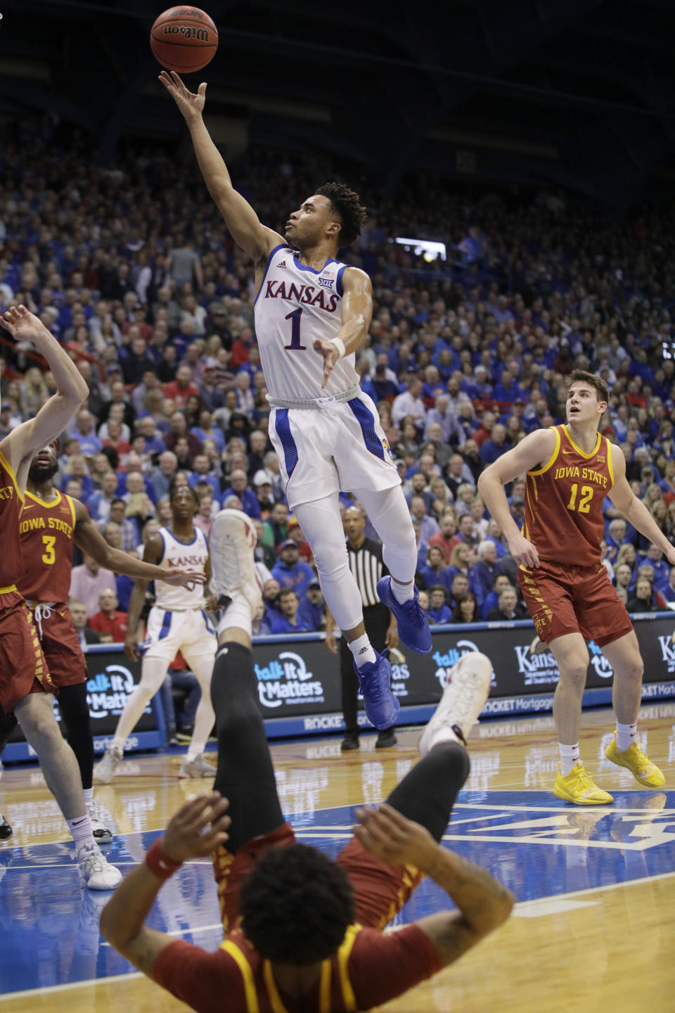 Kansas guard Devon Dotson (1) makes a basket after getting past Iowa State guard Prentiss Nixon, bottom, during the first half of an NCAA college basketball game in Lawrence, Kan., Monday, Feb. 17, 2020. (AP Photo/Orlin Wagner)