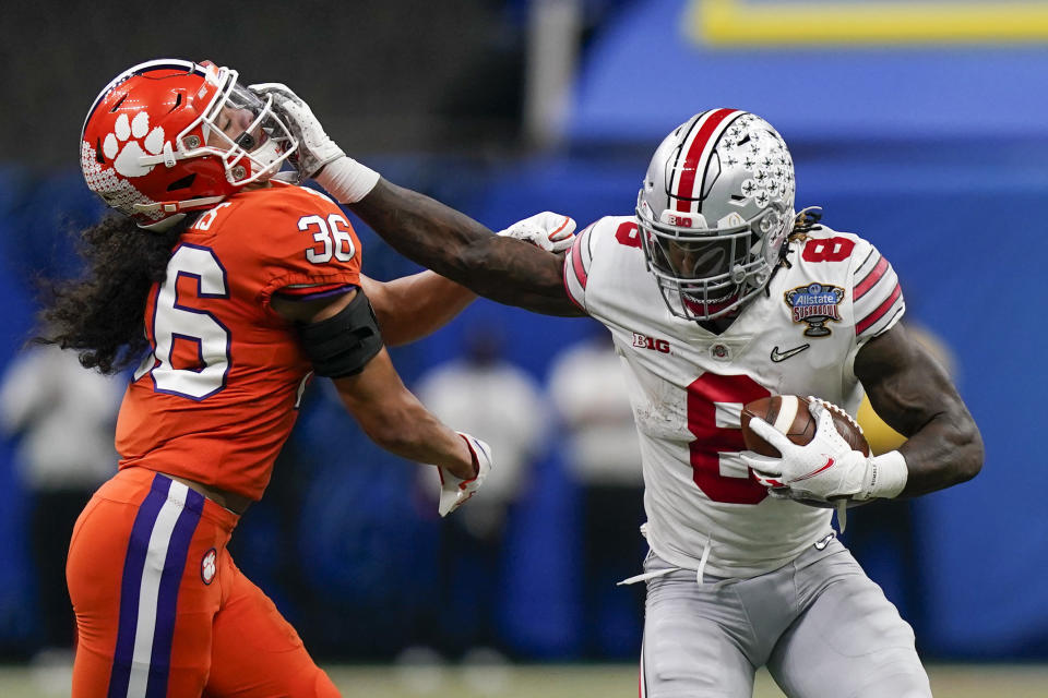 Ohio State running back Trey Sermon runs past Clemson safety Lannden Zanders during the first half of the Sugar Bowl NCAA college football game Friday, Jan. 1, 2021, in New Orleans. (AP Photo/Gerald Herbert)