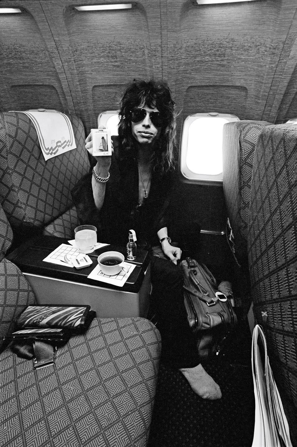 <p>Steven Tyler aboard a plane before an Aerosmith show in Michigan in 1976.</p>