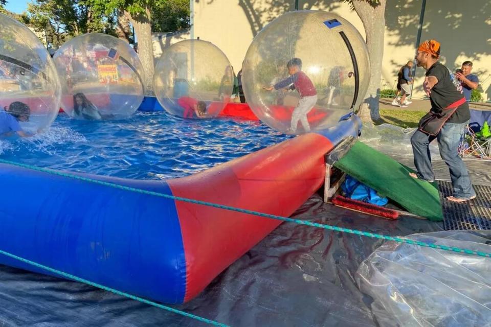 Santa Barbara County Fair-goers prove you can walk on water at an outdoor play area at the Santa Maria Fairpark. Janene Scully/Noozhawk photo