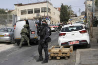 An Israeli policeman secures a shooting attack site in east Jerusalem, Saturday, Jan. 28, 2023. A Palestinian gunman opened fire in east Jerusalem on Saturday, wounding at least two people less than a day after another attacker killed seven outside a synagogue there in the deadliest attack in the city since 2008. (AP Photo/Mahmoud Illean)