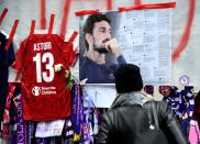 <p>Football fans hang scarves and tributes to late Fiorentina football team captain Davide Astori on the fence of the team stadium on March 7, 2018 in Florence. Italian footballer Davide Astori likely died from a cardiac arrest linked to the slowing of his heart rate following the initial results of his autopsy. Fiorentina and Astori’s former club Cagliari announced they will retire his number 13 shirt in honour of the 31-year-old Italy international, who was found dead in his hotel room on Sunday ahead of a Serie A match at Udinese. / AFP PHOTO / Filippo MONTEFORTE (Photo credit should read FILIPPO MONTEFORTE/AFP/Getty Images) </p>