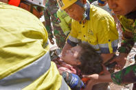 <p>Rescue workers and soldiers carry a woman, who survived after being trapped in rubble since Sunday’s earthquake, in Tanjung, North Lombok, Indonesia, Aug. 7, 2018. (Photo: Antara Foto/Zabur Karuru via Reuters) </p>