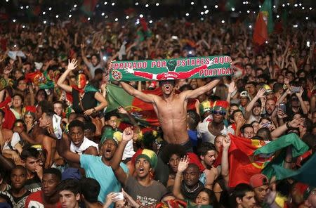 Fans of Portugal react as they watch the Euro 2016 final between Portugal and France at a public screening in Lisbon, Portugal, July 10, 2016. REUTERS/Rafael Marchante