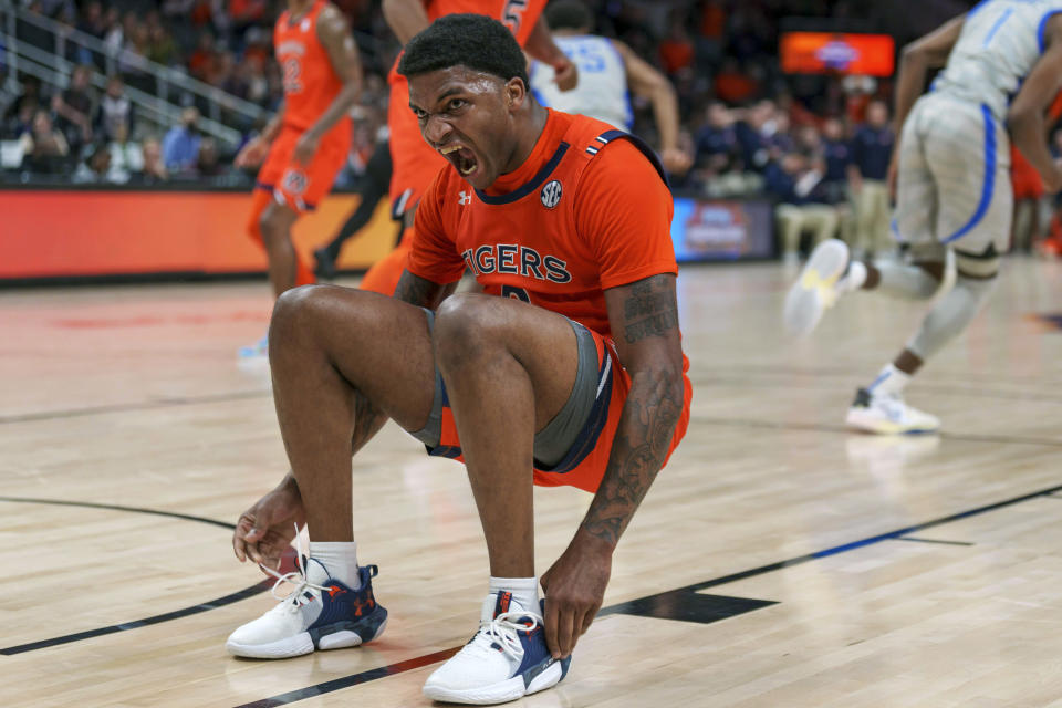 Auburn guard K.D. Johnson (0) reacts after breaking up a play by Memphis during the first-half of an NCAA college basketball game, Saturday, Dec. 10, 2022, in Atlanta. (AP Photo/Erik Rank)