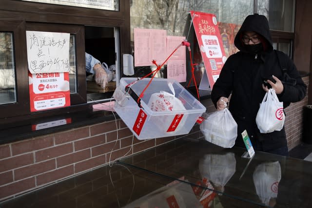 A man collects his food order 