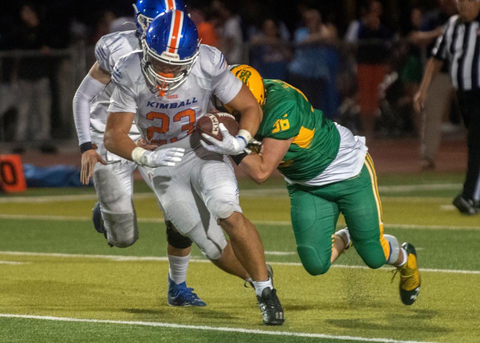 Kimball's Jaden Ramirez, right, tries to get a way from Tracy's Wesley Finton during a varsity football game at Tracy's Wayne Schneider Stadium in Tracy.