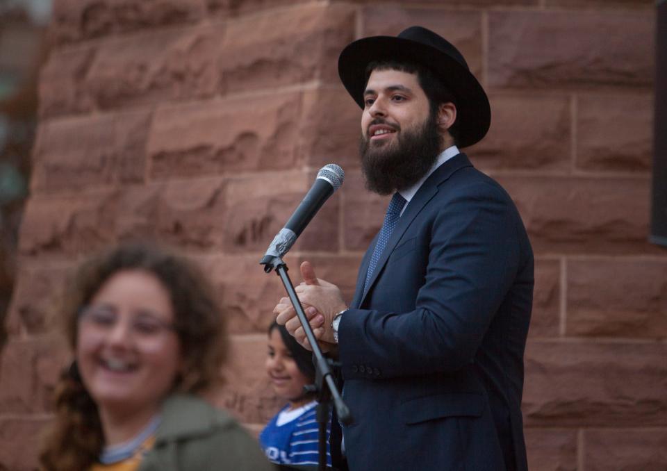Under the direction of Rabbi Mendy Cohen, members of the community gather to celebrate the start of Hanukkah at the Town Square Park Sunday, Dec. 22, 2019.
