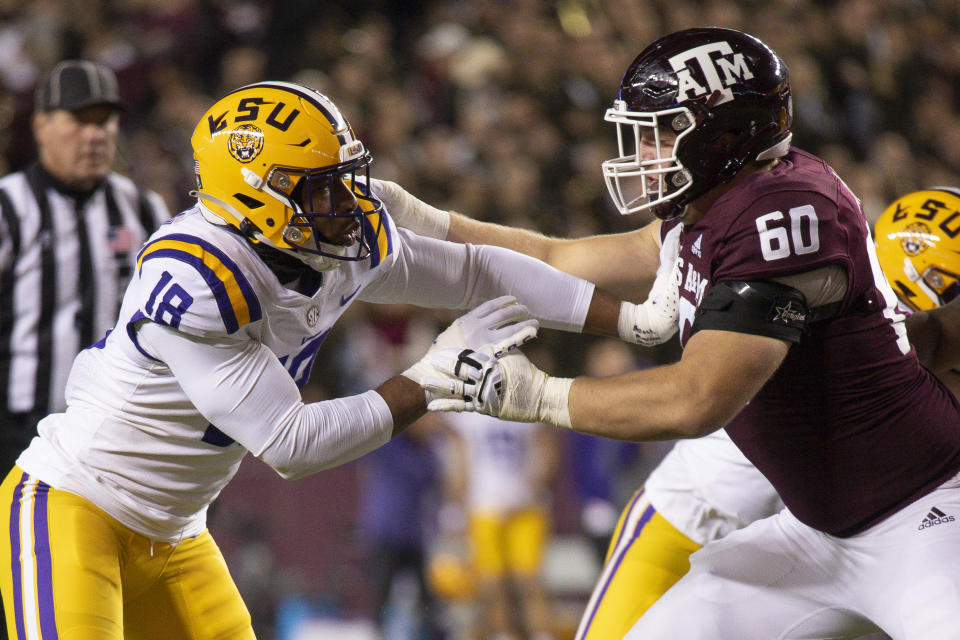 Nov 26, 2022; College Station, Texas; Texas A&M Aggies offensive lineman Trey Zuhn III (60) blocks LSU Tigers defensive end BJ Ojulari (18) during the first quarter at Kyle Field. Jerome Miron-USA TODAY Sports