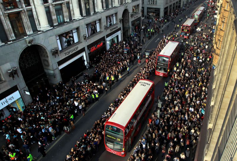FILE PHOTO: Crowds line the street waiting for model Kate Moss to launch her 15th Kate Moss Topshop collection at Topshop's flagship store on Oxford Street in London