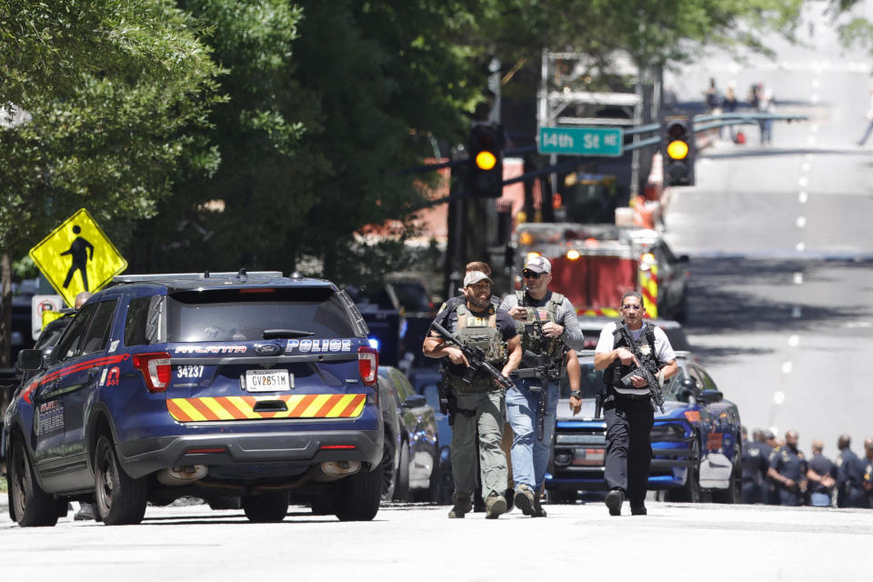 Law enforcement officers arrive near the scene of an active shooter on Wednesday, May 3, 2023 in Atlanta.  / Credit: Alex Slitz / AP