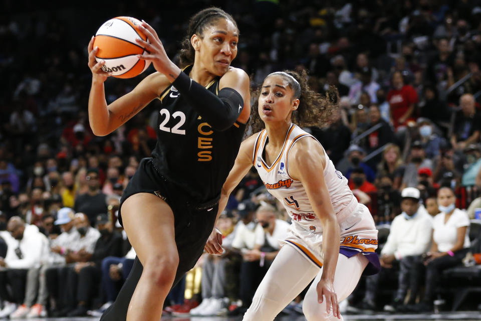 Las Vegas Aces forward A'ja Wilson (22) drives to the basket against Phoenix Mercury guard Skylar Diggins-Smith during the second half of Game 5 of a WNBA basketball playoff series Friday, Oct. 8, 2021, in Las Vegas. (AP Photo/Chase Stevens)