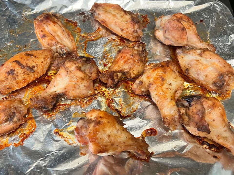 Baked chicken wings on baking sheet