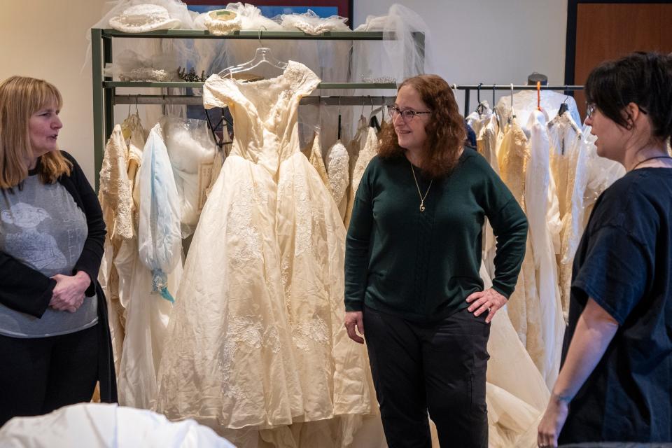 Apr 4, 2024; Fair Lawn, NJ, United States; The Maurice M. Pine Free Public Library has a lending library of wedding dresses. Samantha Sadkin (right) and her mother Nancy Sadkin (left) talk about gowns with Library Director Adele Puccio.