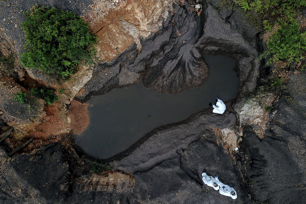 Hazmat personnel from the Kelantan Fire and Rescue Department take water samples at the Kuala Koh Orang Asli settlement in Gua Musang June 11, 2019. — Bernama pic