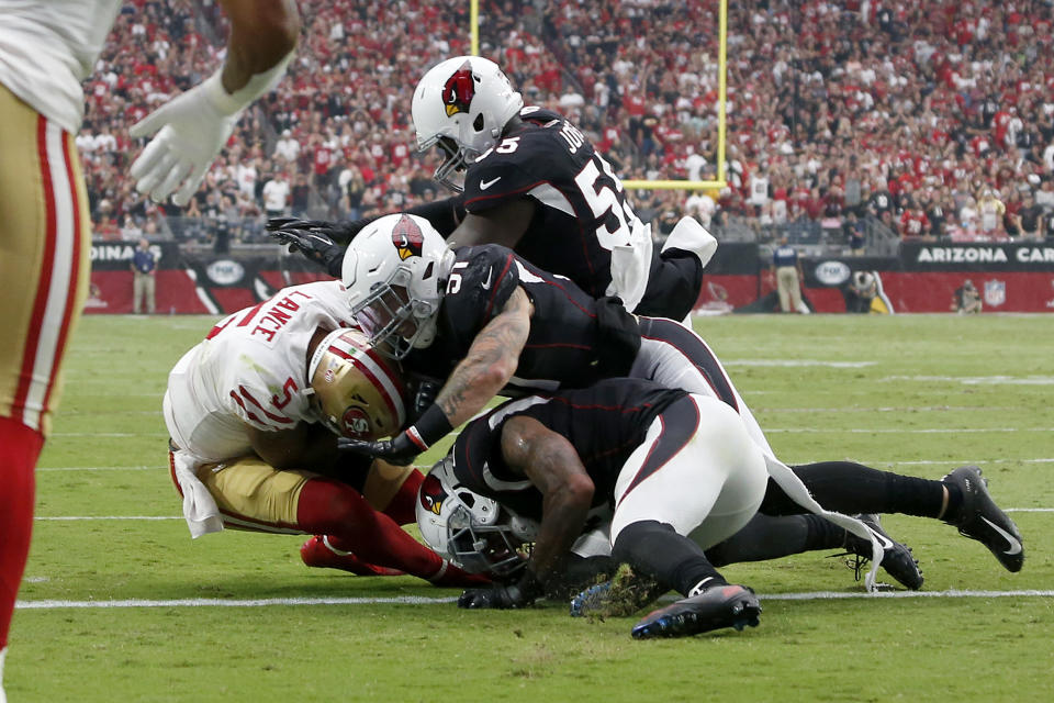 San Francisco 49ers quarterback Trey Lance (5) is stopped short of the goal line on fourth down as he is hit by Arizona Cardinals linebacker Tanner Vallejo (51) during the first half of an NFL football game, Sunday, Oct. 10, 2021, in Glendale, Ariz. (AP Photo/Ralph Freso)