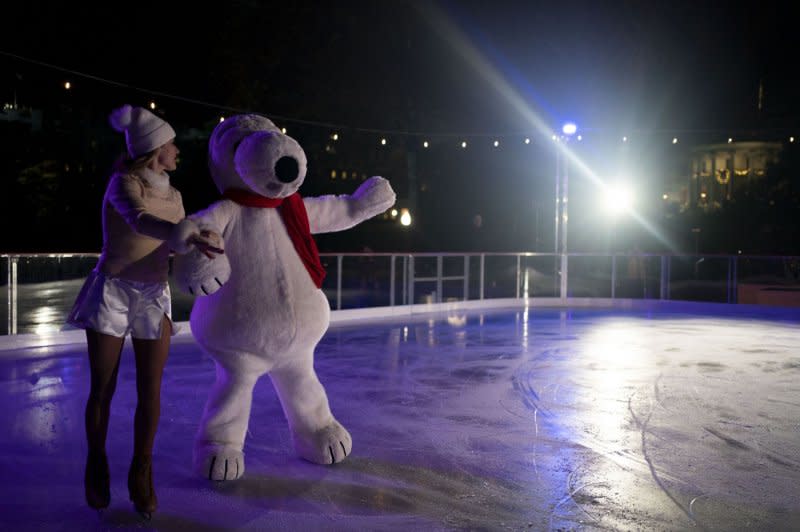 Snoopy and Skating Director at Snoopy Home Ice Kim Navarro perform Wednesday during an event hosted by first lady Jill Biden to unveil the White House Holiday Ice Rink on the South Lawn of the White House in Washington, D.C. Photo by Bonnie Cash/UPI