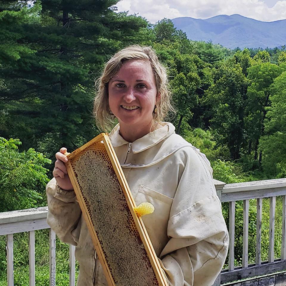 Shanti Volpe, founder of the Shanti Elixirs, holds a beehive. The beverage company uses honey in its products, which are created and bottled in the Blue Ridge Mountains of Western North Carolina.