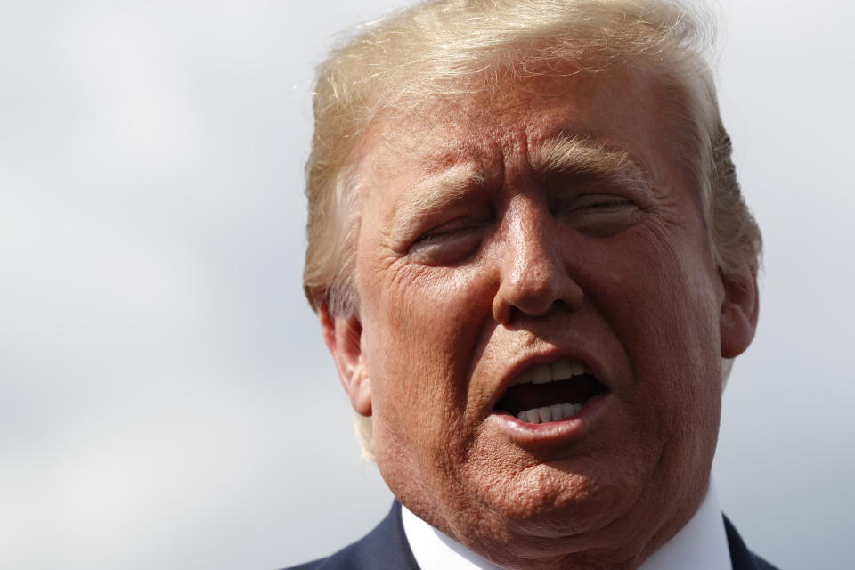 President Donald Trump speaks to the media before boarding Air Force One in Morristown, N.J., Sunday, Aug. 4, 2019. (AP Photo/Jacquelyn Martin)