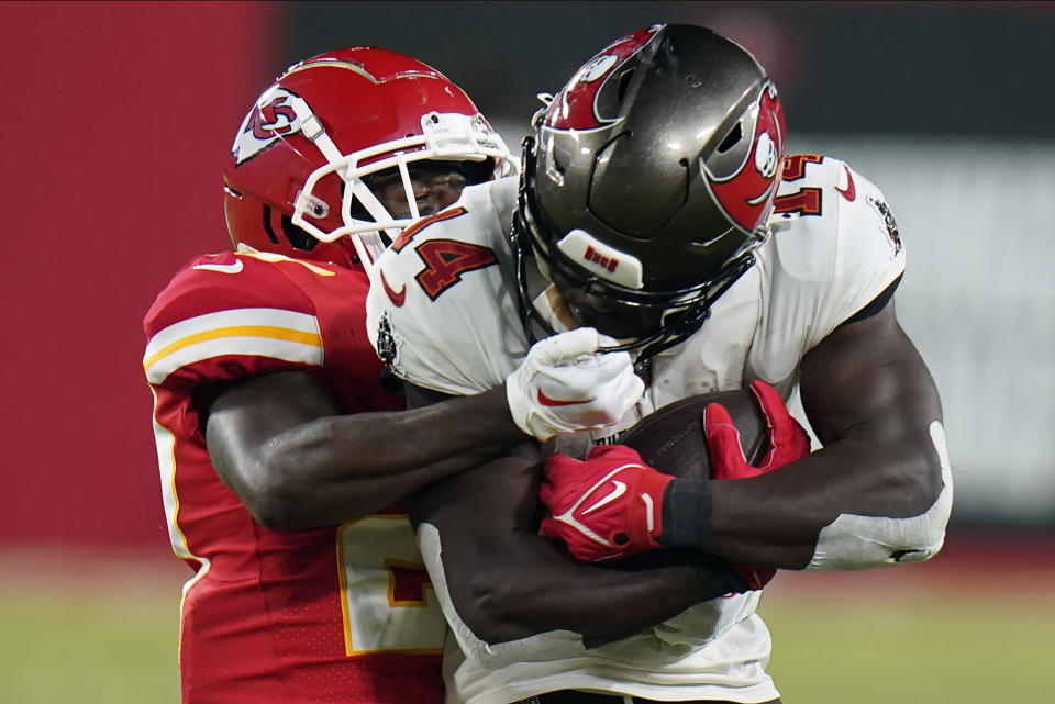 Kansas City Chiefs cornerback Rashad Fenton (27) grabs the face mask of Tampa Bay Buccaneers wide receiver Chris Godwin (14) during the second half of an NFL football game Sunday, Oct. 2, 2022, in Tampa, Fla. No penalty was called on the play. (AP Photo/Chris O'Meara)