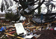 Debris lies on yard after a tornado moved through Adairsville, Ga. Wednesday, Jan. 30, 2013. A fierce storm system that roared across northwest Georgia has left at least one person dead and a trail of damage that included demolished buildings in downtown Adairsville and vehicles overturned on Interstate 75 northwest of Atlanta. A tornado touched down in Adairsville, and authorities confirmed that at least one person was killed in the town about 60 miles northwest of Atlanta. (AP Photo/David Goldman)