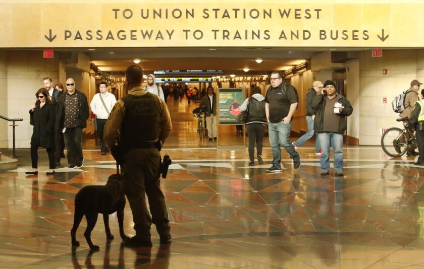 LOS ANGELES, CA - DECEMBER 01, 2016 - Los Angeles County Sheriff's Deputy C. Brown with K-9 "Wilson" monitor pedestrians making their way through Patsaouras Transit Plaza at Union Station on Thursday, December 01, 2016 as the Metropolitan Transportation Authority will consider a major shake-up in how Los Angeles County's sprawling bus and rail system is policed. (Al Seib / Los Angeles Times)