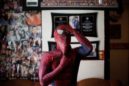 Moises Vazquez, 26, known as Spider-Moy, a computer science teaching assistant at the Faculty of Science of the National Autonomous University of Mexico (UNAM), who teaches dressed as a comic superhero Spider-Man, adjusts his mask before leaving home in Iztapalapa neighbourhood, in Mexico City, Mexico, May 27, 2016. REUTERS/Edgard Garrido