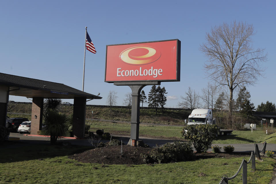A U.S. flag flies near the entrance of an Econo Lodge motel in Kent, Wash., Wednesday, March 4, 2020. King County Executive Dow Constantine said Wednesday that the county had purchased the 85-bed motel south of Seattle to house patients for recovery and isolation due to the COVID-19 coronavirus. (AP Photo/Ted S. Warren)