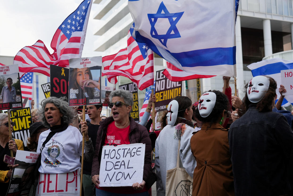 Friends, family members and supporters of hostages protest.