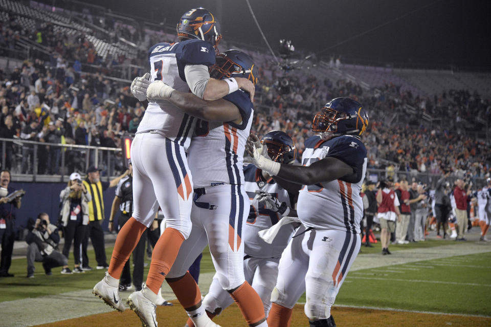 Orlando Apollos quarterback Garrett Gilbert, left, is congratulated by teammates after catching a pass from receiver Jalin Marshall for a 5-yard touchdown during the first half of an Alliance of American Football game against the Atlanta Legends earlier this month. (AP)