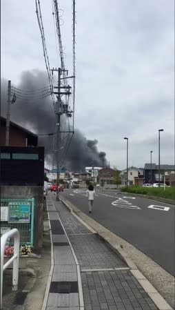 Social media video grab of smoke billowing from a fire at the Kyoto Animation studio in Kyoto