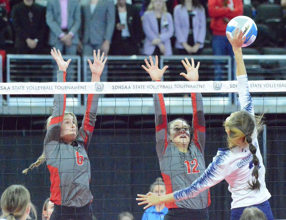 Chester Area's Emmerson Eppard (6) and Serena Larson (12) go up for the block against Burke's Johanna Vaughn during their Class A semifinal match in the state high school volleyball tournament on Friday, Nov. 18, 2022 in the Denny Sanford PREMIER Center.