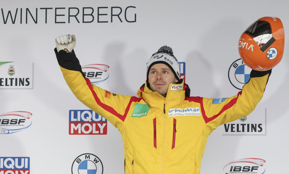 First placed Christopher Grotheer from Germany celebrates after the second run of the men's skeleton World Cup race in Winterberg, Germany, Friday, Jan. 6, 2023. (Friso Gentsch/dpa/dpa via AP)
