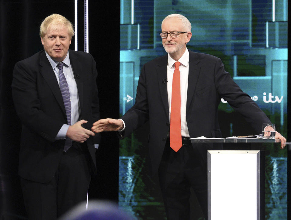 In this photo issued by ITV, Boris Johnson, left, and Jeremy Corbyn, shake hands during their election head-to-head debate live on TV, in Manchester, England, Tuesday, Nov. 19, 2019. Prime Minister Boris Johnson and Jeremy Corbyn are set to go head-to-head in their first live televised debate Tuesday evening, as the UK prepares for a General Election on Dec. 12. (ITV via AP)