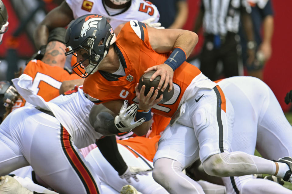 Denver Broncos quarterback Bo Nix runs for a first down against the Tampa Bay Buccaneers on a fourth and one play during the first half of an NFL football game, in Tampa, Fla. on Sunday, Sept. 22, 2024. (AP Photo/Jason Behnken)