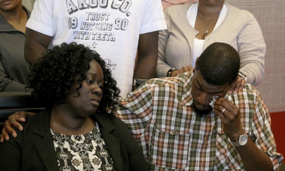 Odell Edwards wipes away tears as he sits with his wife, Charmaine Edwards, in a law office in Dallas on Monday.