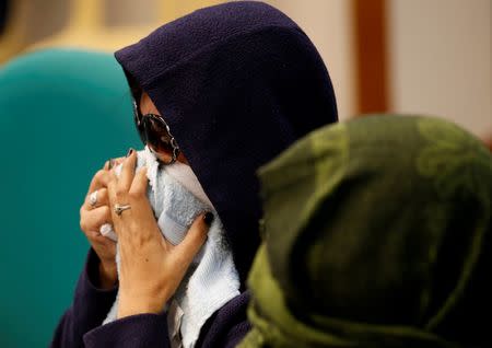 Family members of people alleged by police as drug pushers and were killed during an illegal drugs "meth raid", wear masks during a Senate hearing regarding people killed during a crackdown on illegal drugs in Pasay, Metro Manila, Philippines August 23, 2016. REUTERS/Erik De Castro