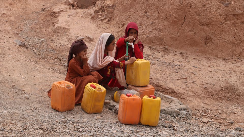 Girls fetch water from a public tap amid hot weather in Farah Province, Afghanistan, July 26, 2023.   - Mashal/Xinhua/Getty Images