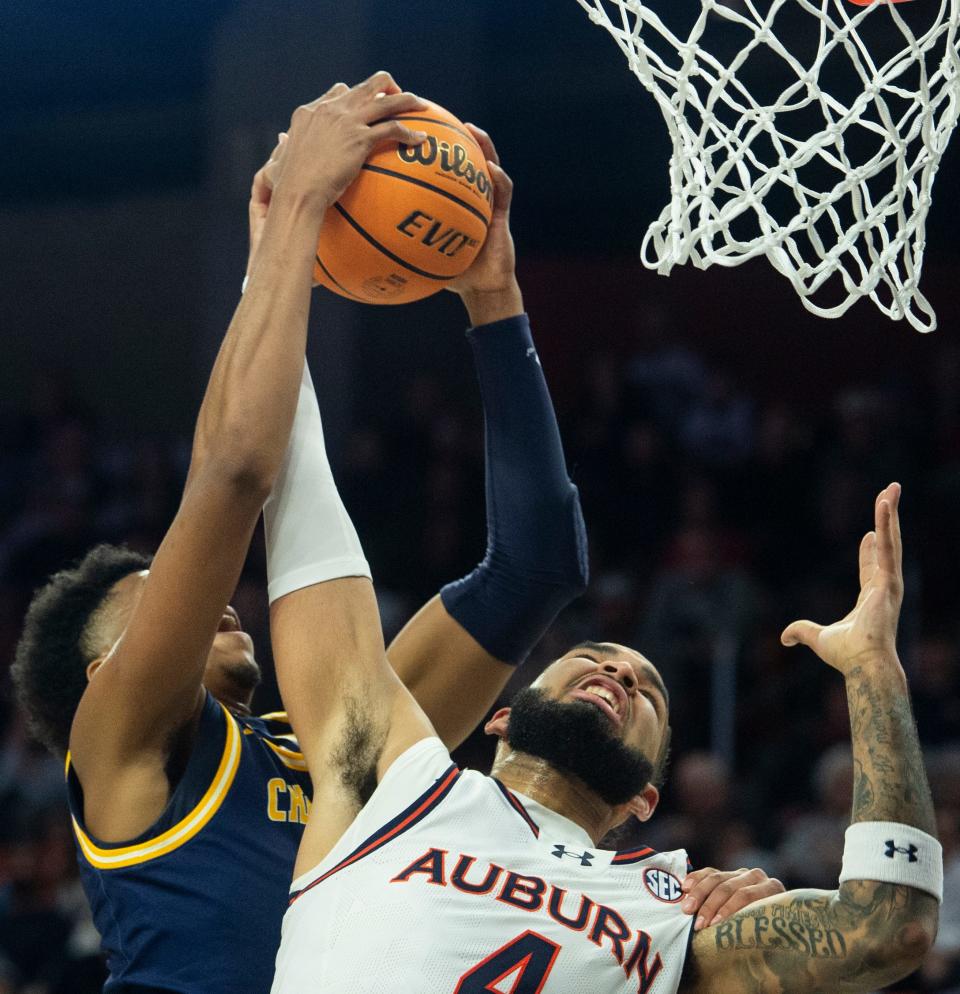 Chattanooga Mocs forward Sam Alexis (4) grabs a rebound over Auburn center Johni Broome (4) in a matchup at Neville Arena in Auburn, Ala., on Saturday, Dec. 30, 2023.