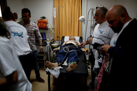 A local man is examined by volunteer doctors of the Aegean Team after a heart incident on the island of Fournoi, Greece, May 12, 2017. REUTERS/Alkis Konstantinidis