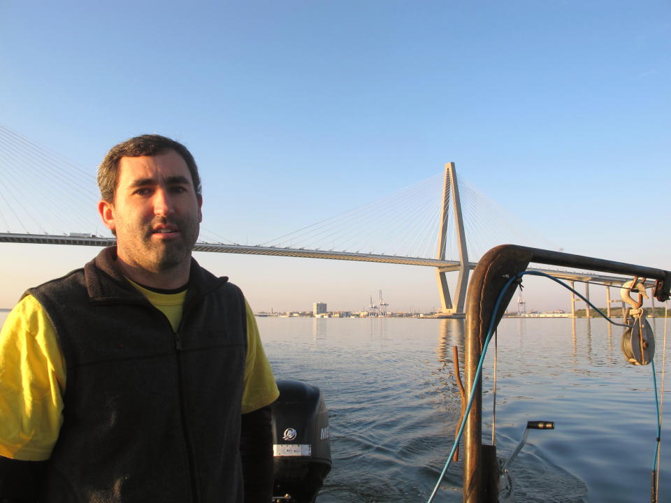 Coastal Carolina University researcher Jeff Marshall stands next to a deployed sonar system on a boat in the harbor in Charleston, S.C. on Friday, October 12, 2012. Researchers from the university are conducting a survey of the harbor bottom as part of a planned $300 million harbor deepening project. (AP Photo/Bruce Smith).