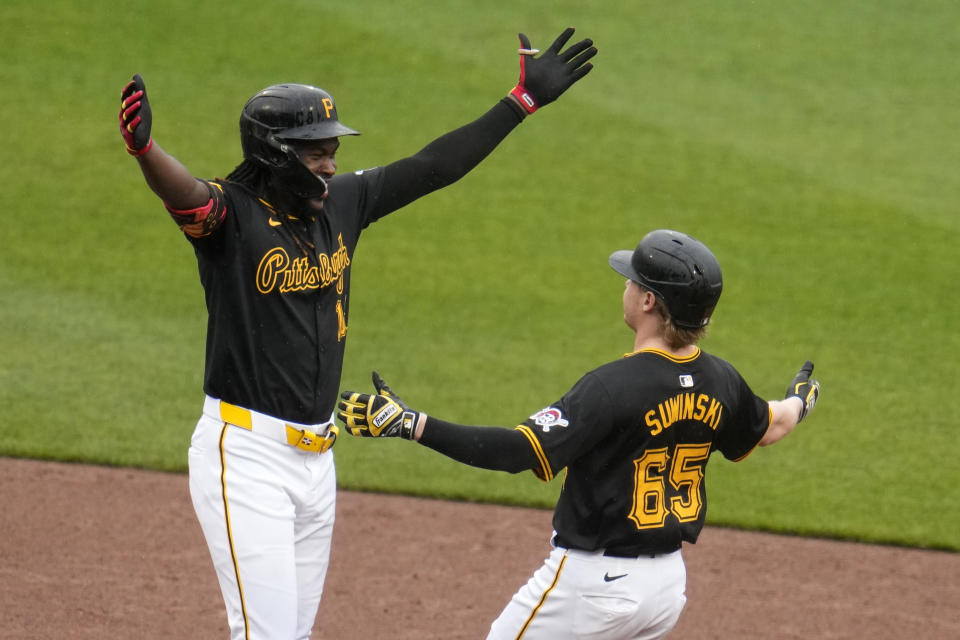 Pittsburgh Pirates' Jack Suwinski (65) celebrates with Oneil Cruz after driving in the game-winning run with a walk-off single off Colorado Rockies relief pitcher Nick Mears during the ninth inning of a baseball game in Pittsburgh, Saturday, May 4, 2024. The Pirates won 1-0. (AP Photo/Gene J. Puskar)