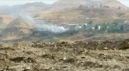 Smoke rises from buildings at the site of a car bomb explosion at a police headquarters in Cizre, located in Turkey's Sirnak province bordering both Syria and Iraq, in this still image from video August 26, 2016. REUTERS/via Reuters TV