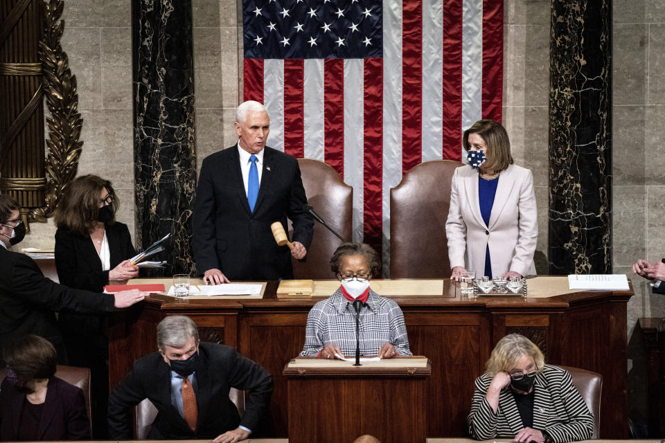 Speaker of the House Nancy Pelosi and Vice President Mike Pence officiate as a joint session of the House and Senate reconvenes to confirm the Electoral College votes at the Capitol on Jan 6, 2021. 