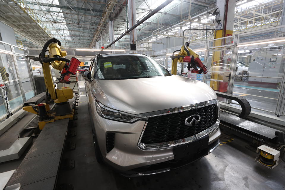 XIANGYANG, CHINA - DECEMBER 18: Employees work on the assembly line of Infiniti QX60 SUV at a factory of Fengshen Xiangyang Automobile Co., Ltd on December 18, 2021 in Xiangyang, Hubei Province of China. (Photo by Wang Hu/VCG via Getty Images)