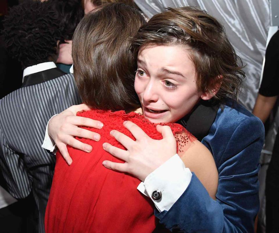 Millie Bobby Brown (L) and Noah Schnapp hug backstage after winning the award for the Outstanding Ensemble in a Drama Series award for 'Stranger Things'