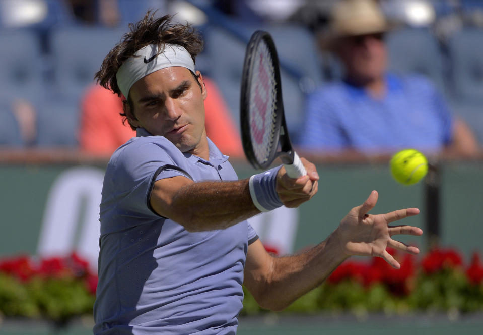 Roger Federer, of Switzerland, hits to Dmitry Tursunov, of Russia, during a third round match at the BNP Paribas Open tennis tournament, Monday, March 10, 2014 in Indian Wells, Calif. (AP Photo/Mark J. Terrill)